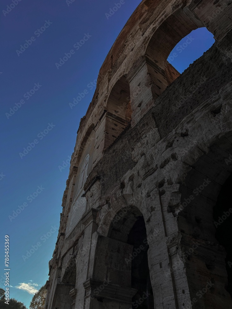 Vertical low-angle shot of a part of the ancient Colosseum