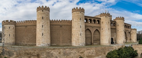 Image of an Aljaferia Palace on the top of the mount under the cloudy blue sky. photo