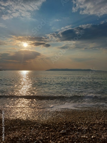 Beautiful rocky beach with the sun reflected on the sea