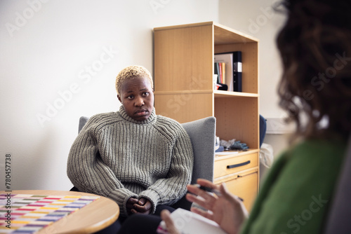 Mid adult woman sitting during therapy session