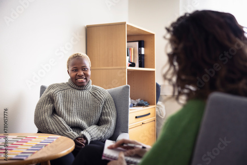 Mid adult woman sitting during therapy session photo