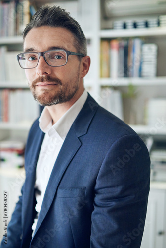Portrait, serious and business man in workplace for career or job in office in Australia. Face, confidence and professional salesman in glasses, entrepreneur and corporate employee in suit at company