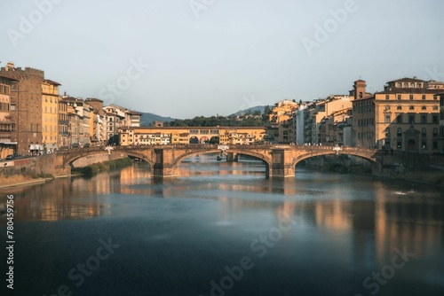 Beautiful view of a bridge over river between the buildings © Wirestock