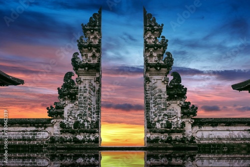 Sunset over Temple gates at Lempuyang Luhur temple in Bali, Indonesia, purple, golden sky background photo