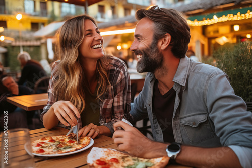 Dating in pizzeria. Handsome smiling couple enjoying in pizza  having fun together. Consumerism  food  lifestyle concept. Tourist on vacation in Italy enjoy leisure activity eating food. Healthy.