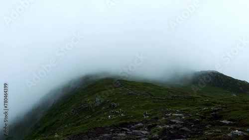 Footage of fog or cloud passing over the Oksen mountain in Norway photo