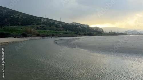 Wallpaper Mural Along the coastal region of Zahara, Spain, water flows, carving a channel into the landscape. Illustrating the concept of natural resilience. Torontodigital.ca