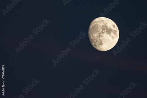 closeup on almost full moon in a dark night sky