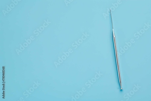 Needle on blue background photo