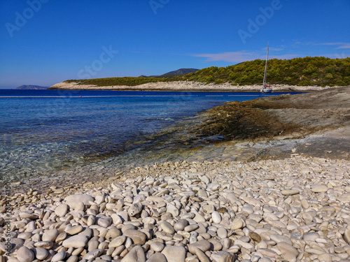Fototapeta Naklejka Na Ścianę i Meble -  Srebrna beach with white pebbles, turquoise sea and forest in the background. Vis island. Right view