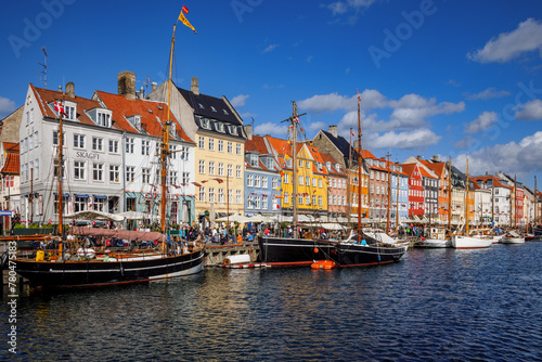 Colourful houses and historic boats in Nyhavn, Copenhagen, Denmark.
