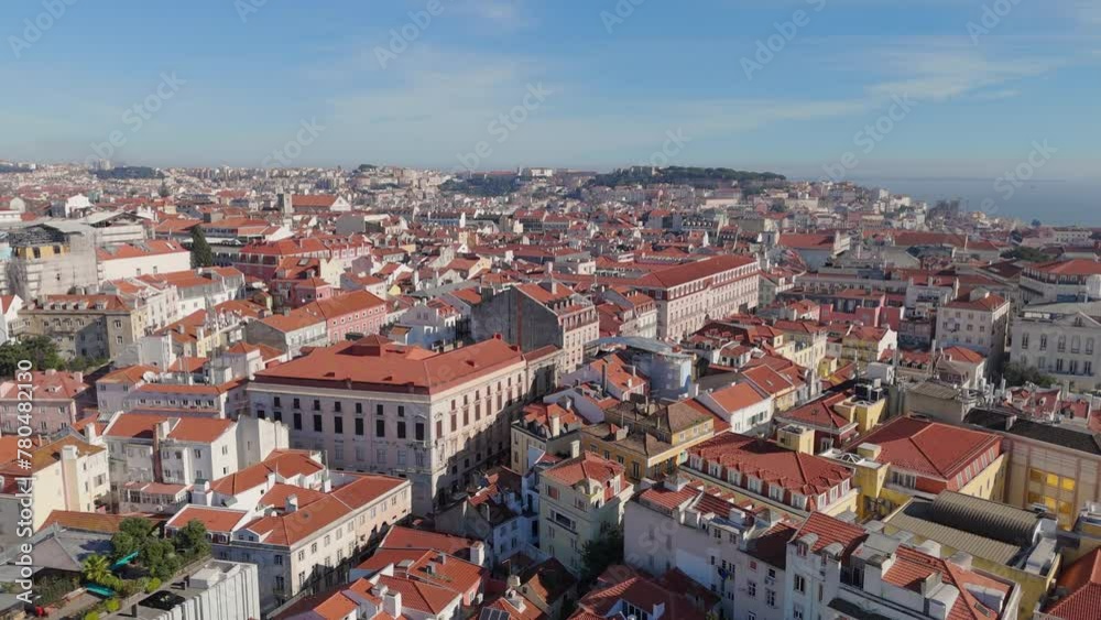 Aerial slow pan across city and tall multi story buildings along Lisbon Portugal dense cityscape Aerial slow pan across city and tall multi story buildings along Lisbon Portugal dense cityscape
