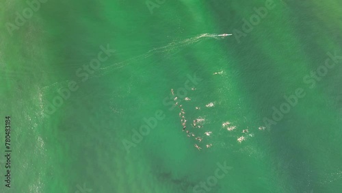 Competitors compete in an ocean surf swimming race at a Australian Surf Life Saving Championships. Drone view photo