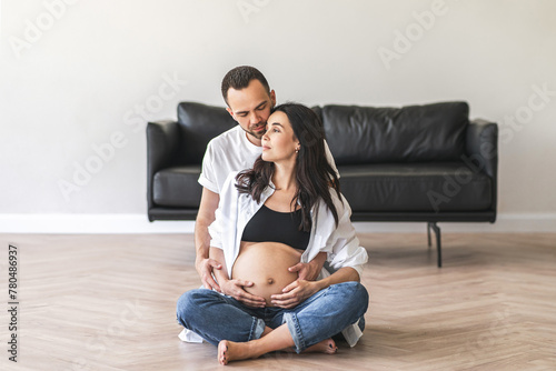 Pregnant woman sitting on floor with husband