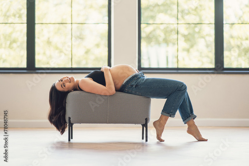 Pregnant woman laying on chair in room