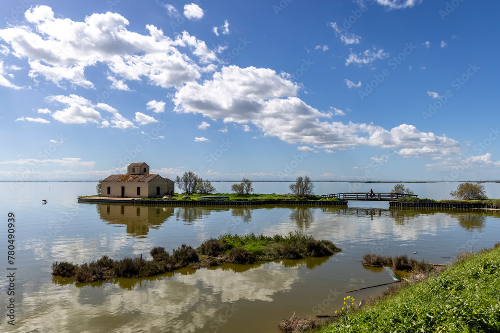 Woman cycles on an e-bike through the Po Delta in Northern Italy