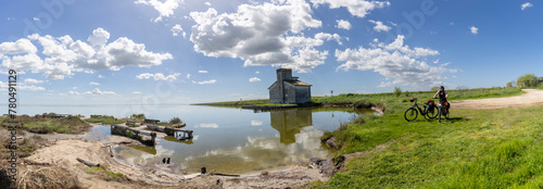 Woman cycles on an e-bike through the Po Delta in Northern Italy