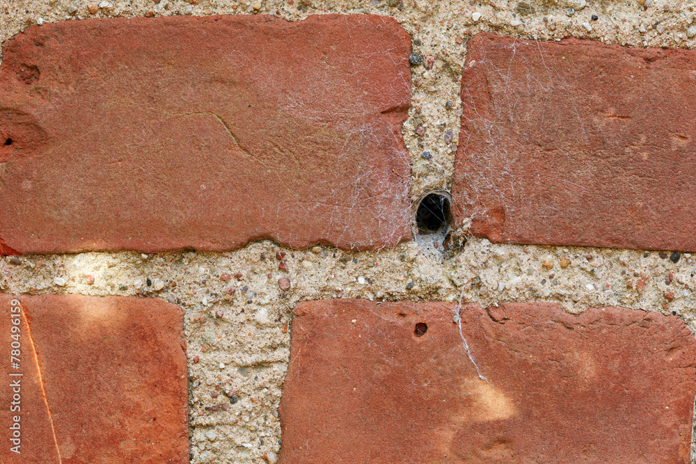 Building, hole and closeup of red, brick wall for texture, background and pattern of exterior structure. Architecture design, construction and surface of material, concrete and cement for decoration Building, hole and closeup of red, brick wall for texture, background and pattern of exterior structure. Architecture design, construction and surface of material, concrete and cement for decoration