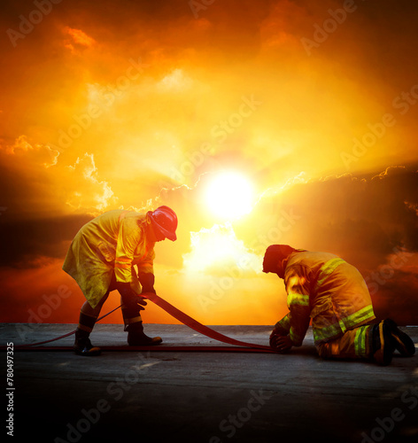 Firefighters are preparing their fire hoses to combat the blaze © stockphoto mania