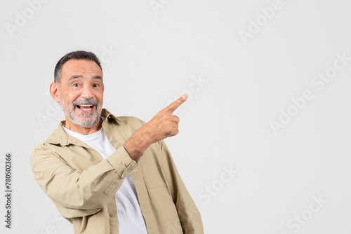 Smiling man pointing to the side, blank space photo