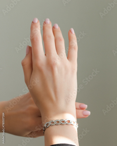 female hand with silver bracelet