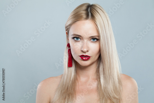 Glamorous young blonde lady with fresh clear skin and long smooth straight hairstile on white background