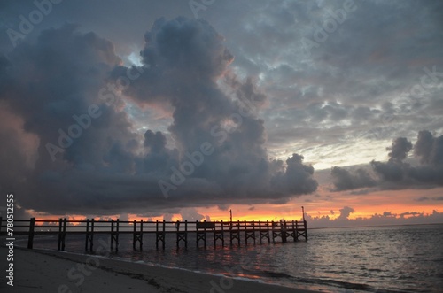 Storm Clouds Over Boat Dock at Sunrise © Renee