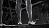 Gymnast's legs perform on the balance beam.