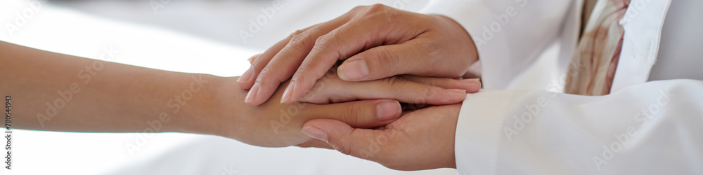 Header with pediatrician touching hands of teenage patient Header with pediatrician touching hands of teenage patient