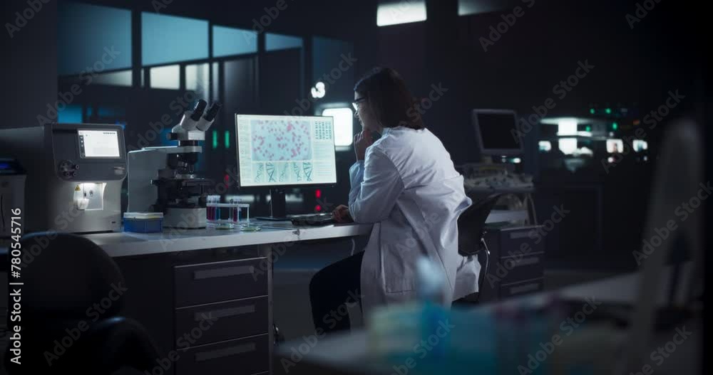 Caucasian Female Scientist Working on a Computer in the Evening. Specialist Using a Gene Sequencing Software. Advanced Biotechnology Lab in a Medical Research and Development Center Caucasian Female Scientist Working on a Computer in the Evening. Specialist Using a Gene Sequencing Software. Advanced Biotechnology Lab in a Medical Research and Development Center