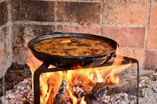 valencian paella over a wood fire photo