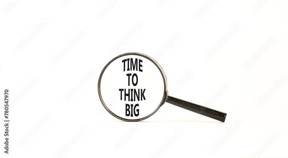 Time to think big symbol. Concept words Time to think big on beautiful magnifying glass. Beautiful white table white background. Business and time to think big concept. Copy space. Time to think big symbol. Concept words Time to think big on beautiful magnifying glass. Beautiful white table white background. Business and time to think big concept. Copy space.