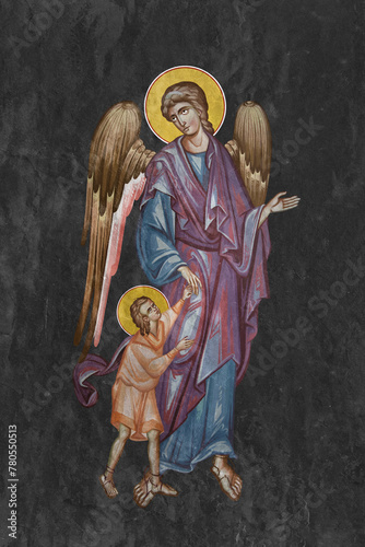 Christian traditional image of Guardian angel. Religious illustration on black stone wall background in Byzantine style