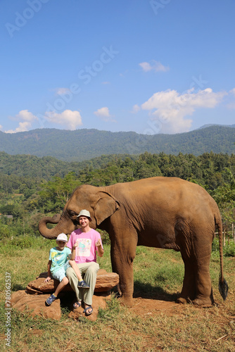 Tourist child, cute kid, man and elephant in Chiang Mai, Thailand. Thai animal. Friendship. Boy feeds asian elephant. Thai nature, scenery, beautiful landscape	
