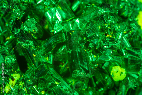 Green crystal mineral stone. Gems. Mineral crystals in the natural environment. Texture of precious and semiprecious stones. Seamless background with copy space colored shiny surface of precious stone