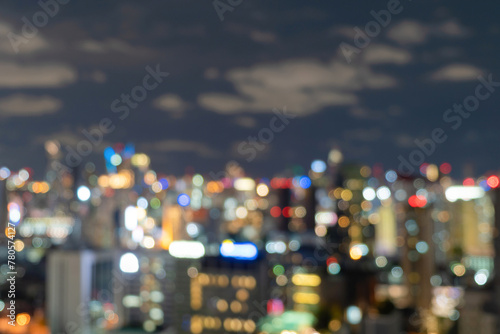 Bokeh abstract background of skyscraper buildings in Bangkok city, Thailand with lights, Blurry photo at night time. Cityscape. © Laiba