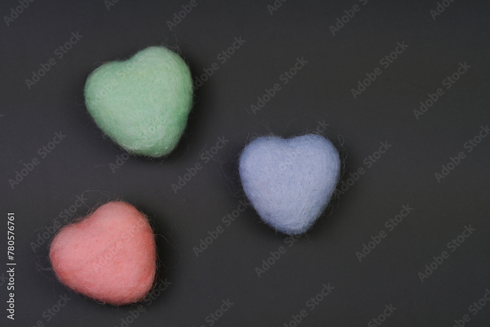 Obraz premium Three Heart Shaped Wool Balls on Table