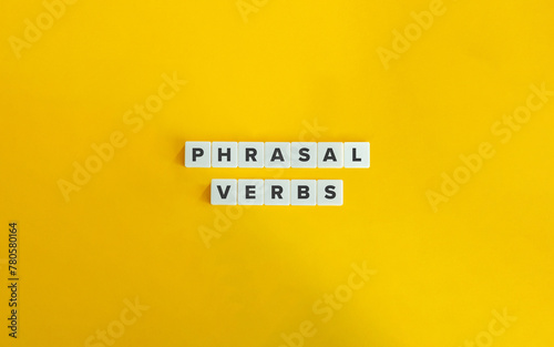 Phrasal Verbs Banner. English Grammar Concept. Text on Block Letter Tiles on Yellow Background. Minimal Aesthetics. photo