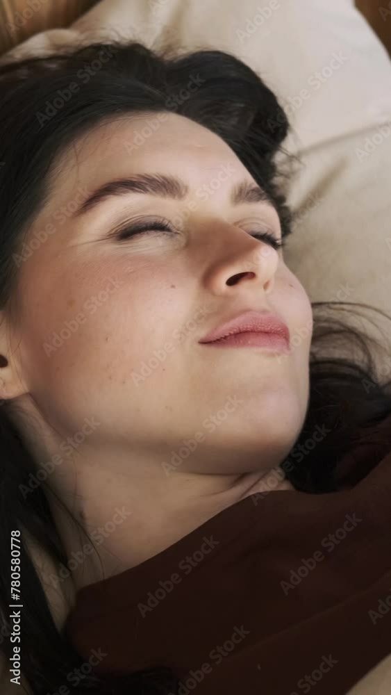 Close up portrait of a happy Caucasian woman wake up and stretching in the morning at home bedroom. Looking and smilng at camera. Vertical video. Close up portrait of a happy Caucasian woman wake up and stretching in the morning at home bedroom. Looking and smilng at camera. Vertical video.