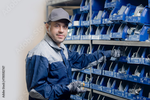 Industrial worker in warehouse of steel fittings for hydraulic hoses in manufacturing factory