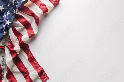 A fragment of the US flag on a white surface with copyspace for text. Background for design. © Eugene_Photo