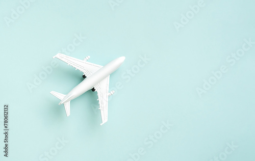 White airplane on the blue background. Vacation travel concept.
