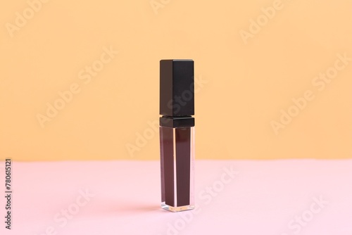 One purple lip gloss on color background © New Africa