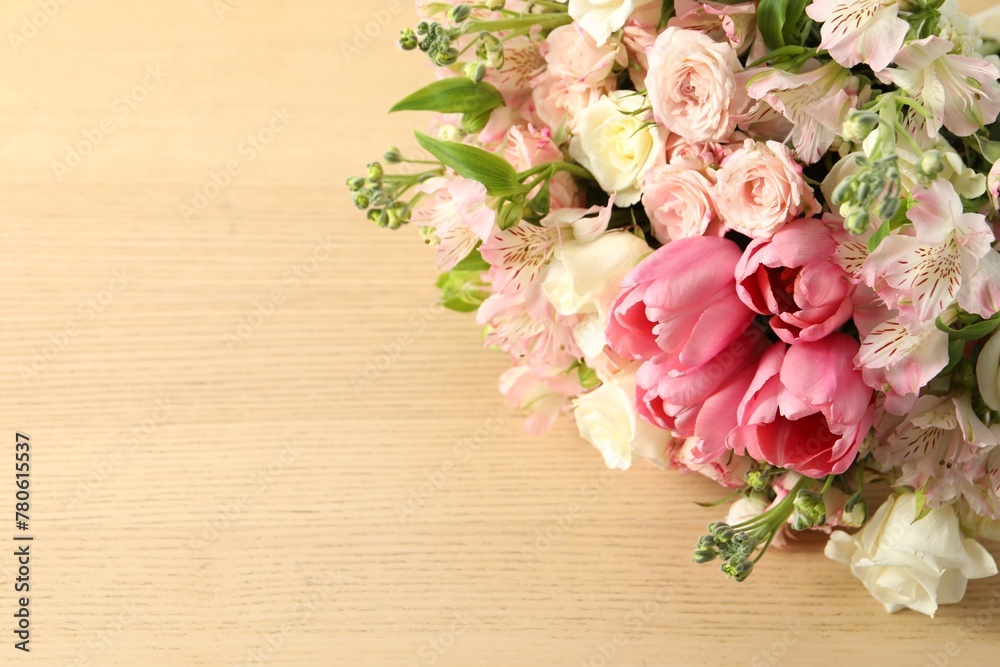Beautiful bouquet of fresh flowers on wooden table, closeup. Space for text