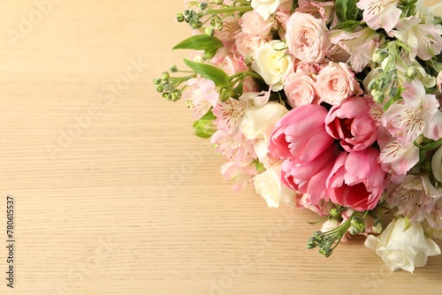 Beautiful bouquet of fresh flowers on wooden table, closeup. Space for text © New Africa
