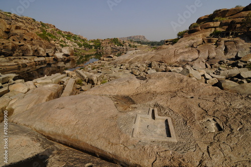 Tungabhadra River and stone cut Shiva Linga, Hampi, Karnataka, India photo