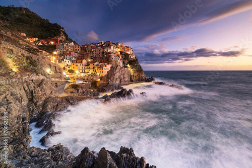 Magical light envelops the famous village of Manarola during an autumn sunset, Manarola, Cinque Terre National Park, UNESCO World Heritage Site, La Spezia, Liguria, Italy photo