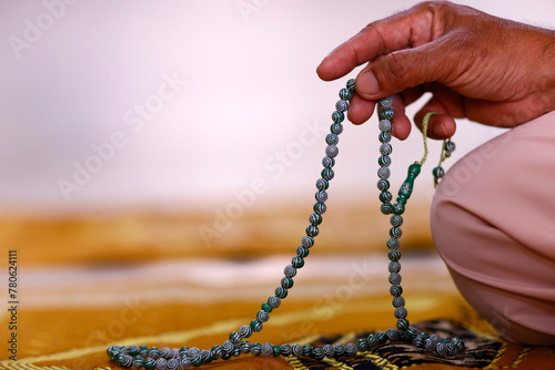 Close-up of hand of Muslim man praying with Islamic prayer beads, Chau Doc, Vietnam, Indochina, Southeast Asia photo