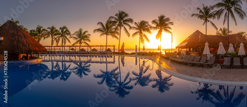 View of sunrise and palm tree reflections in hotel pool near Puerto Morelos, Caribbean Coast, Yucatan Peninsula, Mexico photo