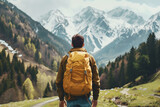 Rear view of backpacker man enjoying beautiful view. Travel and holiday concept